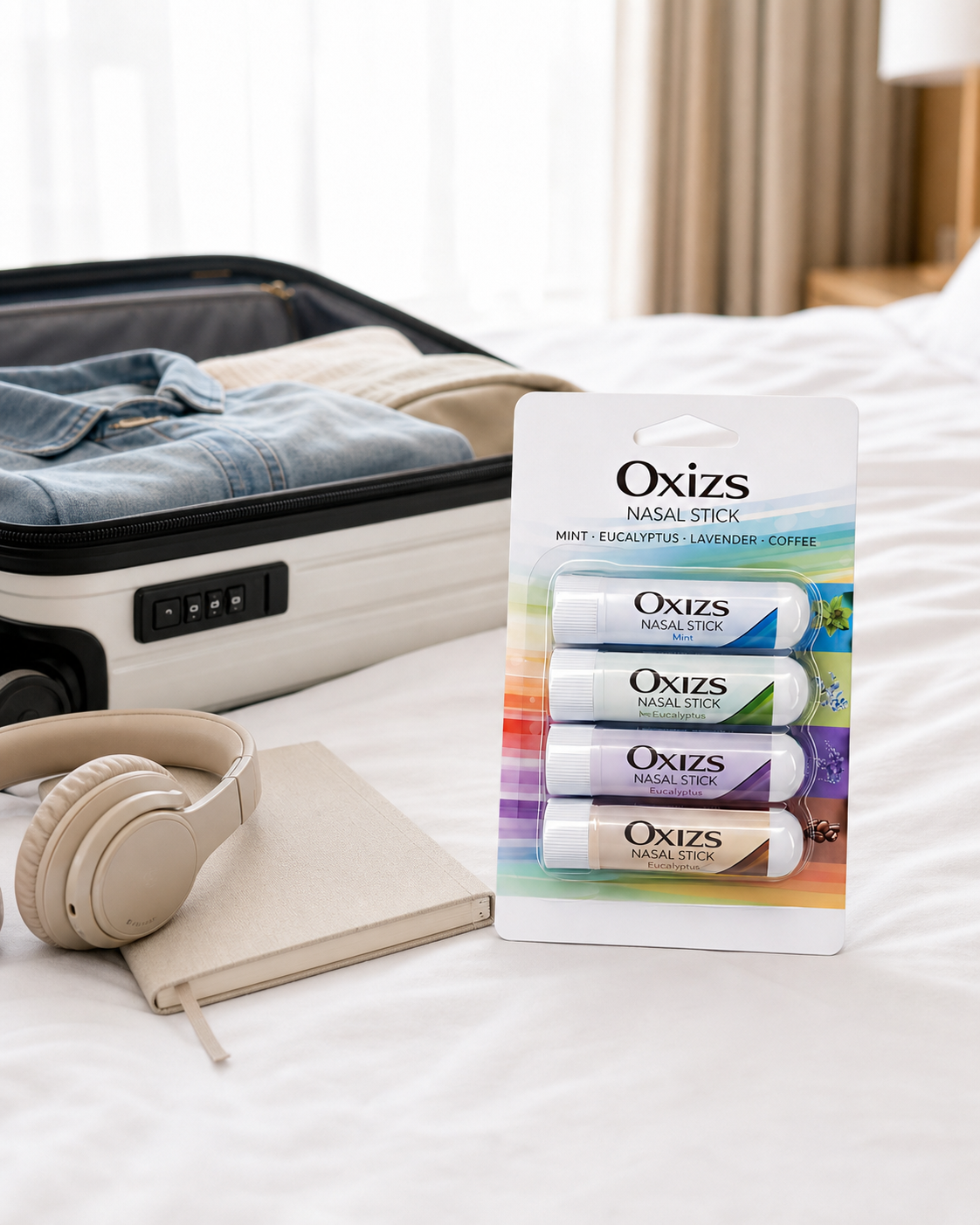 OXIZS Variety 4 Pack beside a carry-on suitcase